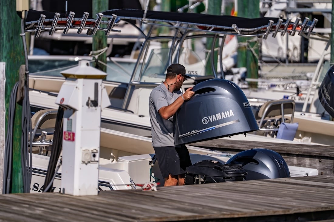 legacy boating club crew working on engine at marina in destin fl
