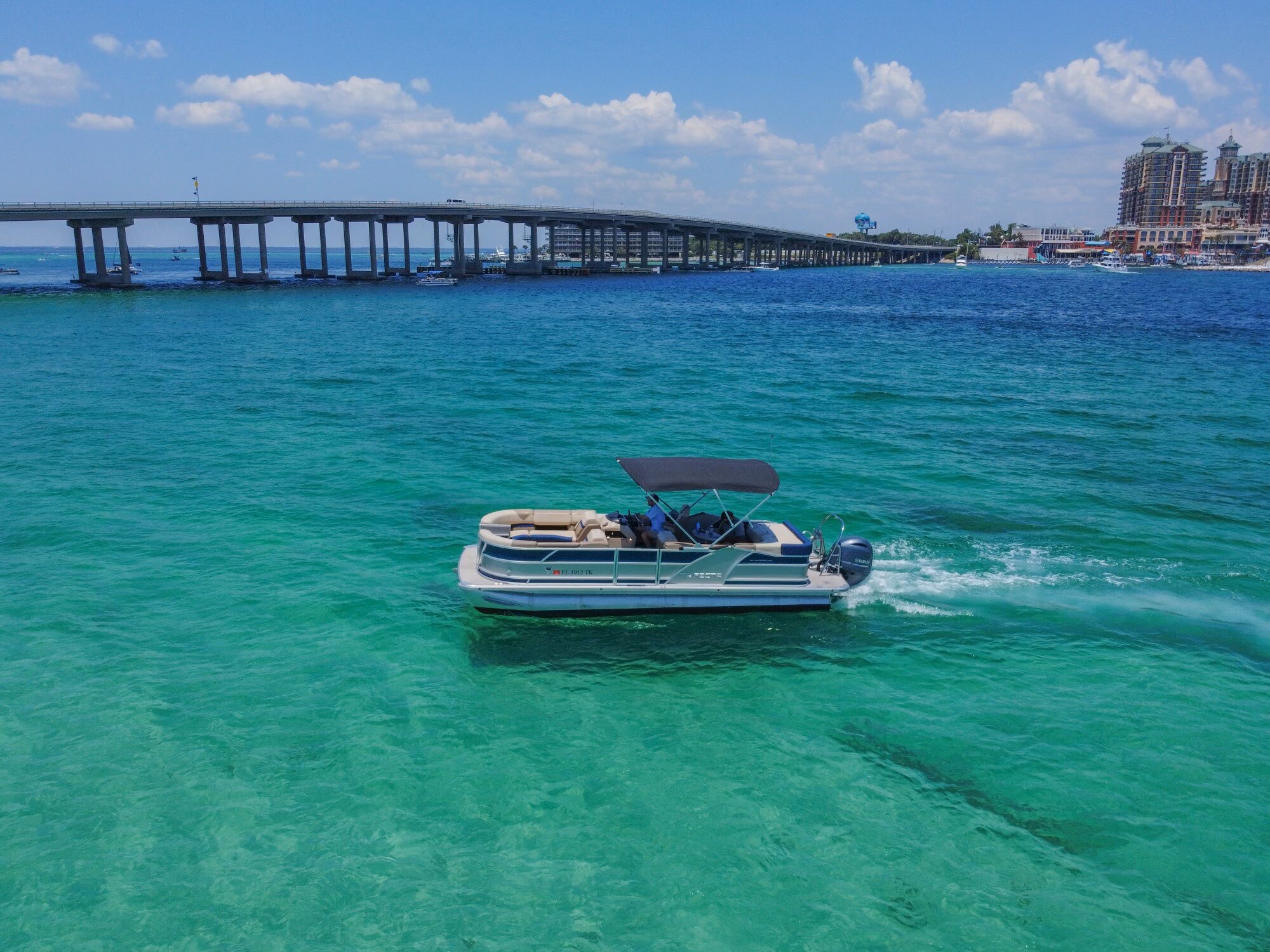 two men driving a pontoon boat in destin florida