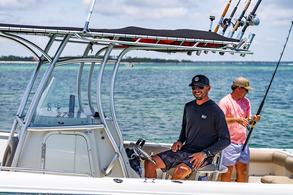 two men aboard a 270 sailfish twin engine fishing boat