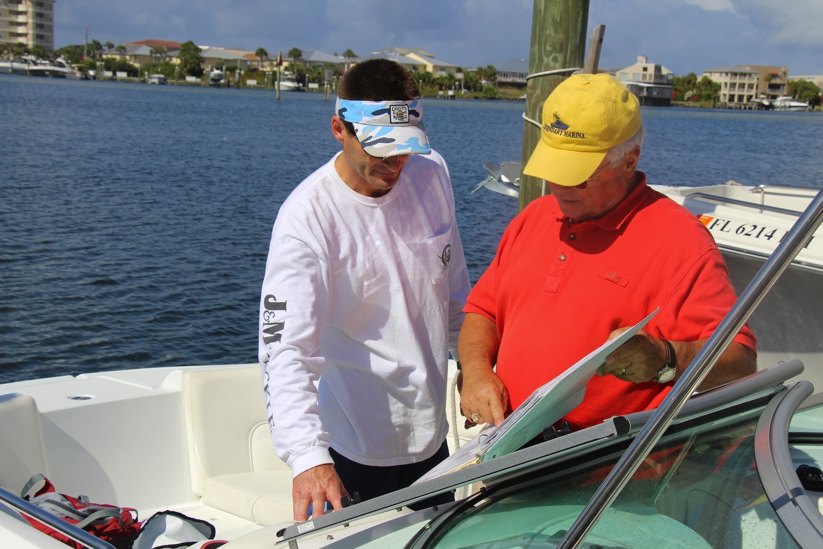 Two men looking at a a map on a Legacy boat
