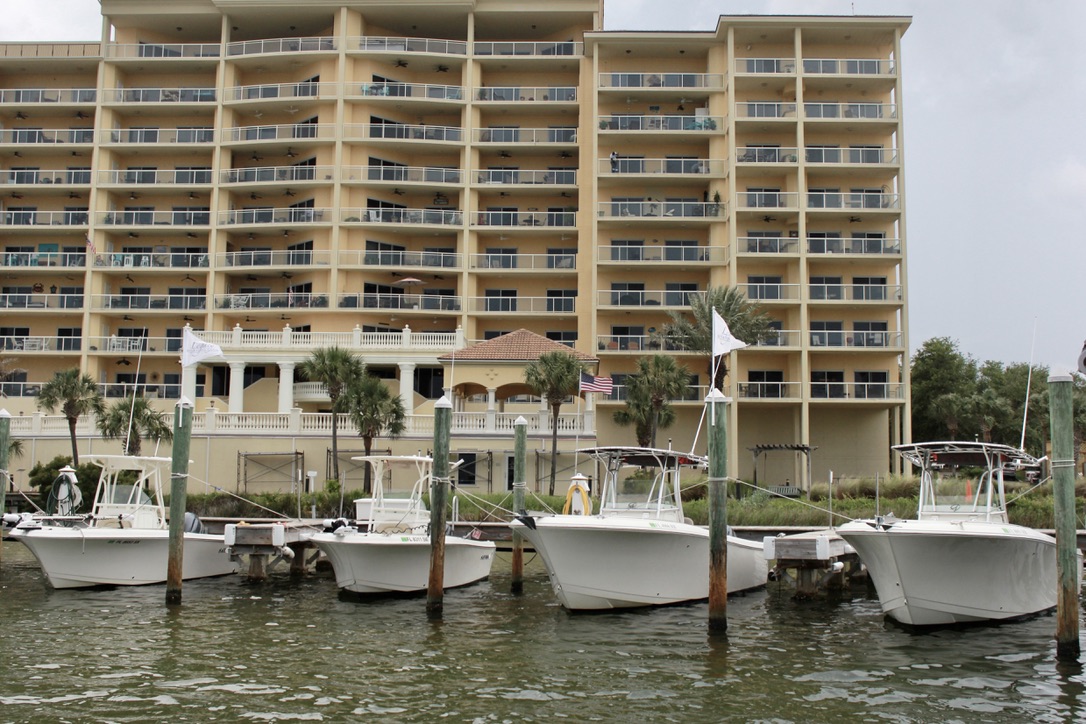 A group of boats in the water at Marbella Yacht Club in Destin, Florida