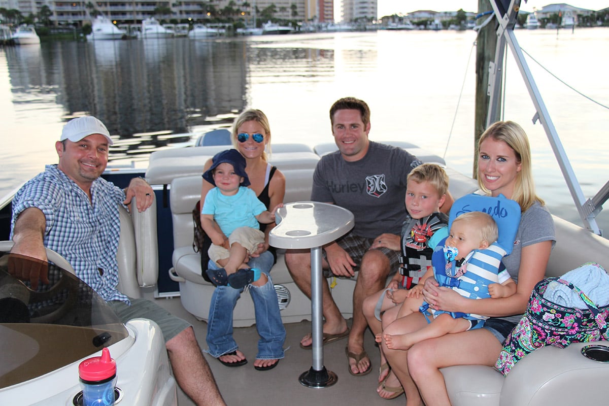 family on a legacy boating club tritoon boat