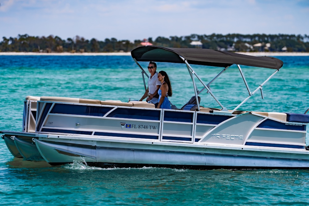 classy couple cruising shallow waters on a tritoon boat