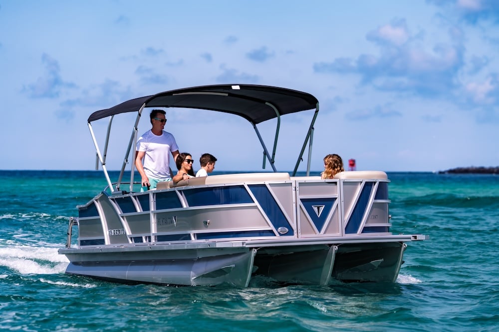 family cruising into shell island waters on tritoon