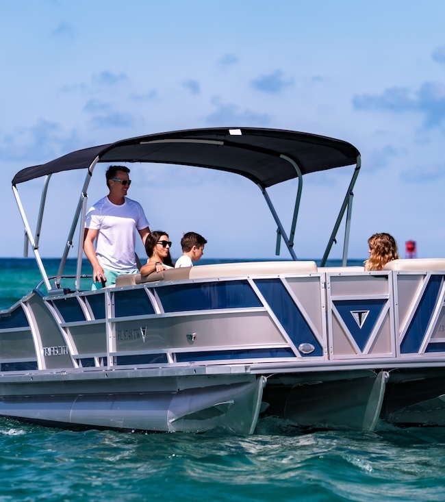 family of four on a Legacy boating club tritoon in Panama City Beach