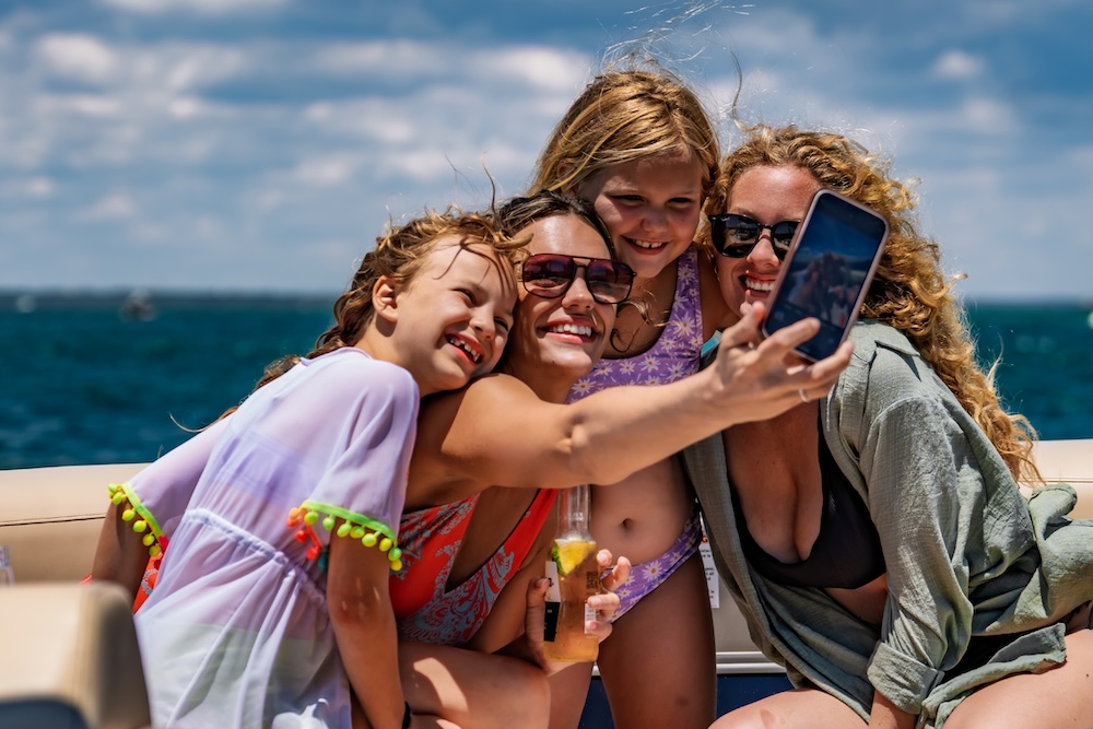 family selfie on tritoon boat at crab island in destin