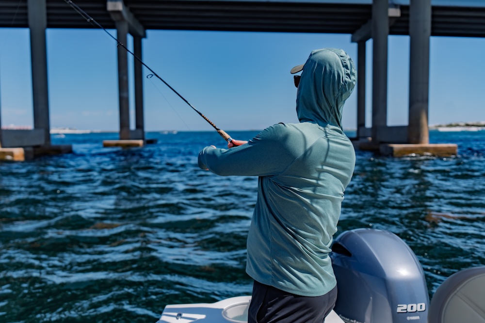 man fishing on a center console boat in destin harbor