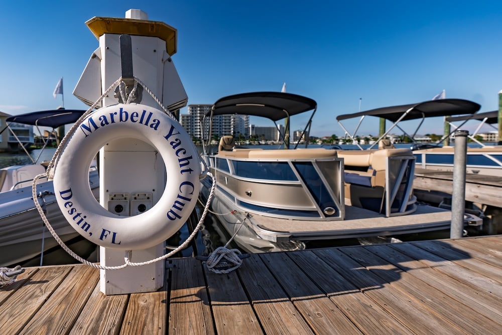 marbella yacht club buoy in front of legacy tritoon boat