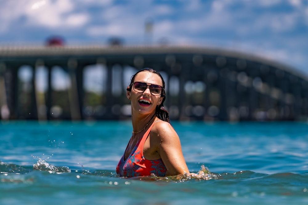 woman swimming and smiling at destin beach